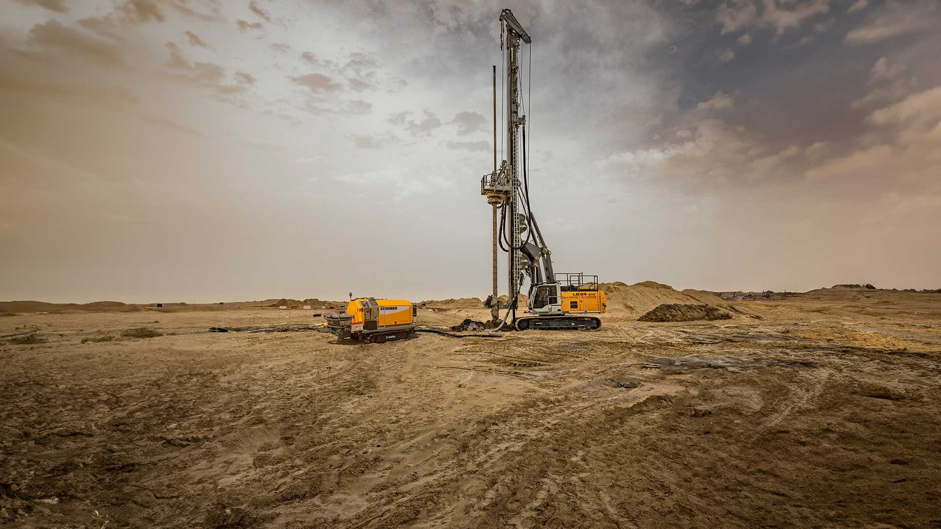 Liebherr LB 24 drill rig and 110 D concrete crawler pump working in Abu Dhabi